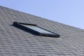Closeup shot of a skylight or Velux window on a slate roof