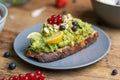 Closeup shot of a slice of brown bread with avocado pasta and berries Royalty Free Stock Photo