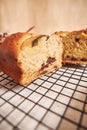 Closeup shot of a slice of delicious banana bread with chocolate chunks and walnut on a table Royalty Free Stock Photo