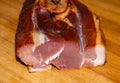 Closeup shot of a slice of smoked pork leg on a wo