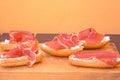 Closeup shot of sliced bread with butter and Jamon on chopping board Royalty Free Stock Photo