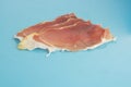 Closeup shot of slices of serrano ham on a blue background Royalty Free Stock Photo