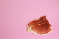 Closeup shot of slices of serrano ham on a pink background Royalty Free Stock Photo