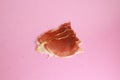 Closeup shot of slices of serrano ham on a pink background Royalty Free Stock Photo