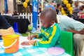 Closeup shot of a small African American child doing a learning activity outdoors