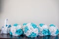 Closeup shot of small bouquets with artificial blue and white flowers with a grey background Royalty Free Stock Photo