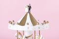 Closeup shot of small bride and groom figurines on top of carousel Royalty Free Stock Photo