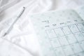 Closeup shot of a small calendar and a pen on the bed Royalty Free Stock Photo