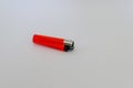 Closeup shot of a small red lighter on white background Royalty Free Stock Photo