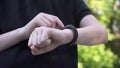 Closeup shot of smart watch with black strap on a hand of child. Sport smart wrist using. Downscale with 6k video