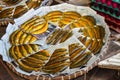 Closeup shot of smoked fish on newspapers on a large tray in the market in Baguio, Philippines