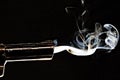 Closeup shot of a smoking gun with s black background Royalty Free Stock Photo