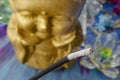 Closeup shot of smoking incense stick with buddha statue in the background Royalty Free Stock Photo