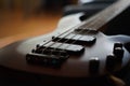 Closeup shot of a smooth body, pickups, bridge, knobs and strings of a bass guitar musical instrument with backlight Royalty Free Stock Photo