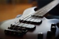 Closeup shot of a smooth body, pickups, bridge, knobs and strings of a bass guitar musical instrument with backlight Royalty Free Stock Photo