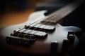 Closeup shot of a smooth body, pickups, bridge, knobs and strings of a bass guitar musical instrument with backlight Royalty Free Stock Photo