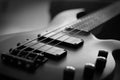 Closeup shot of a smooth body, pickups, bridge, knobs and strings of a bass guitar musical instrument with backlight Royalty Free Stock Photo