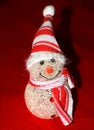 Closeup shot of snowman made of beads isolated in a red background Royalty Free Stock Photo