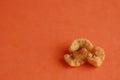 Closeup shot of Spanish fried bacon snack on orange background Royalty Free Stock Photo