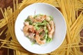 Closeup shot of spinach pasta with fresh shrimp and guajillo chili on a white salad plate Royalty Free Stock Photo