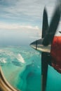 Closeup shot of the spinning airplane propeller in the sky viewed from the window