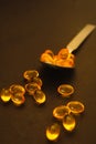 Shot of a spoonful of cod liver oil capsules.