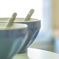 Closeup shot of spoons inside blue bowls