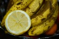 Closeup shot of a squeezed fresh lemon and a bunch of bananas