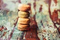 Closeup shot of a stack of delicious macarons on a wooden surface