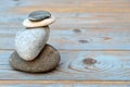 Closeup shot of a stack of flat stones on a wooden table Royalty Free Stock Photo
