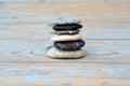 Closeup shot of a stack of flat stones on a wooden table Royalty Free Stock Photo