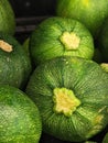 Closeup shot of a stack of fresh, green zucchini arranged in a neat pile on a white background Royalty Free Stock Photo