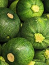 Closeup shot of a stack of fresh, green zucchini arranged in a neat pile on a white background Royalty Free Stock Photo