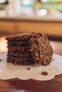 Closeup shot of a stack of freshly baked cookies on a white sheet on a table