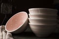 Closeup shot of a stack of pink bowls on the table