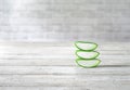 Closeup shot of a stack of sliced fresh aloe vera slices on a wooden table