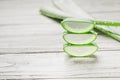 Closeup shot of a stack of sliced fresh aloe vera slices on a wooden table