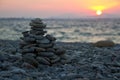 Closeup shot of a stack of stones on a beach at sunset Royalty Free Stock Photo