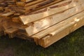 A closeup shot of a stack of wooden boards on a grass Royalty Free Stock Photo