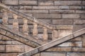 Closeup shot of stairs going up next to a wall made of grey stone Royalty Free Stock Photo