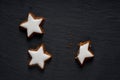 Closeup shot of star-shaped German cinnamon cookies called Zimtstern on black background