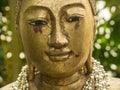 Closeup shot of a statue of Gautama Buddha in Thailand with a blurry background