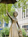 Closeup shot of the statue of Mary Poppins holding an umbrella and suitcase, London