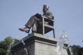 Closeup shot of the statue of Soekarno sitting at a chair in front of Stadium of Manahan