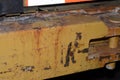 Closeup shot of steel yellow car bumper covered in rust