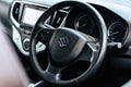 Closeup shot of the steering wheel of a black Maruti Suzuki Baleno Alpha car