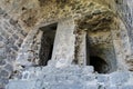 Closeup shot of a stone cave with open doors. Ancient deteriorated building in Tatev Monastery