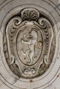 Closeup shot of a stone lion carving on a building of the Roman Catholic church in Pisa Royalty Free Stock Photo