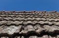 Closeup shot of the stone roof of the old building with the blue sky in the background Royalty Free Stock Photo