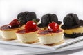 Closeup shot of strawberry and chocolate cookie cheese pies on a white plate Royalty Free Stock Photo